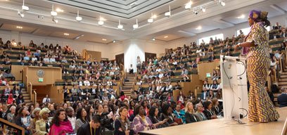 Female speaker in theatre at Women Leaders in Global Health event